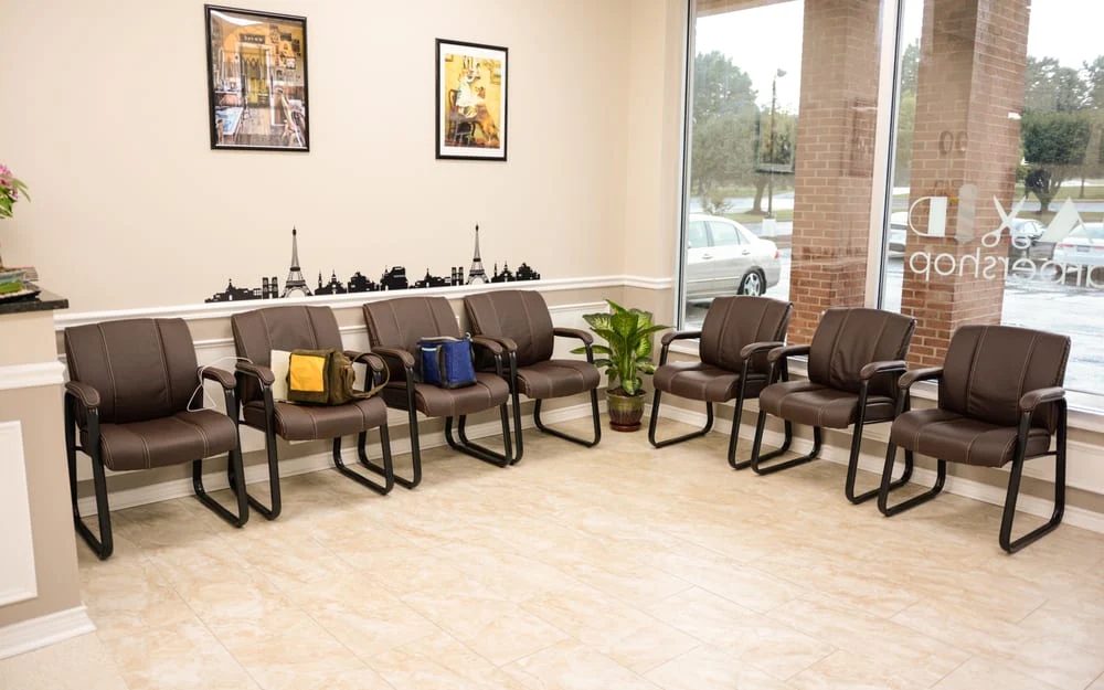 The waiting area, with leather chairs along the window looking out onto the plaza.