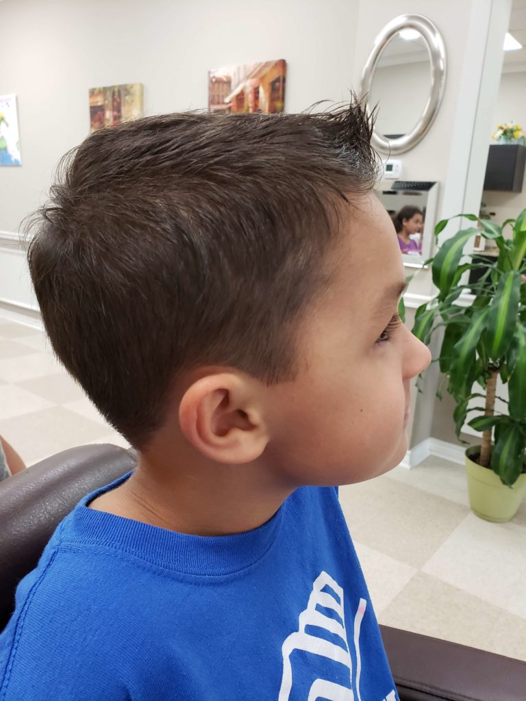 A boy's textured crop, tapered short around the ear.