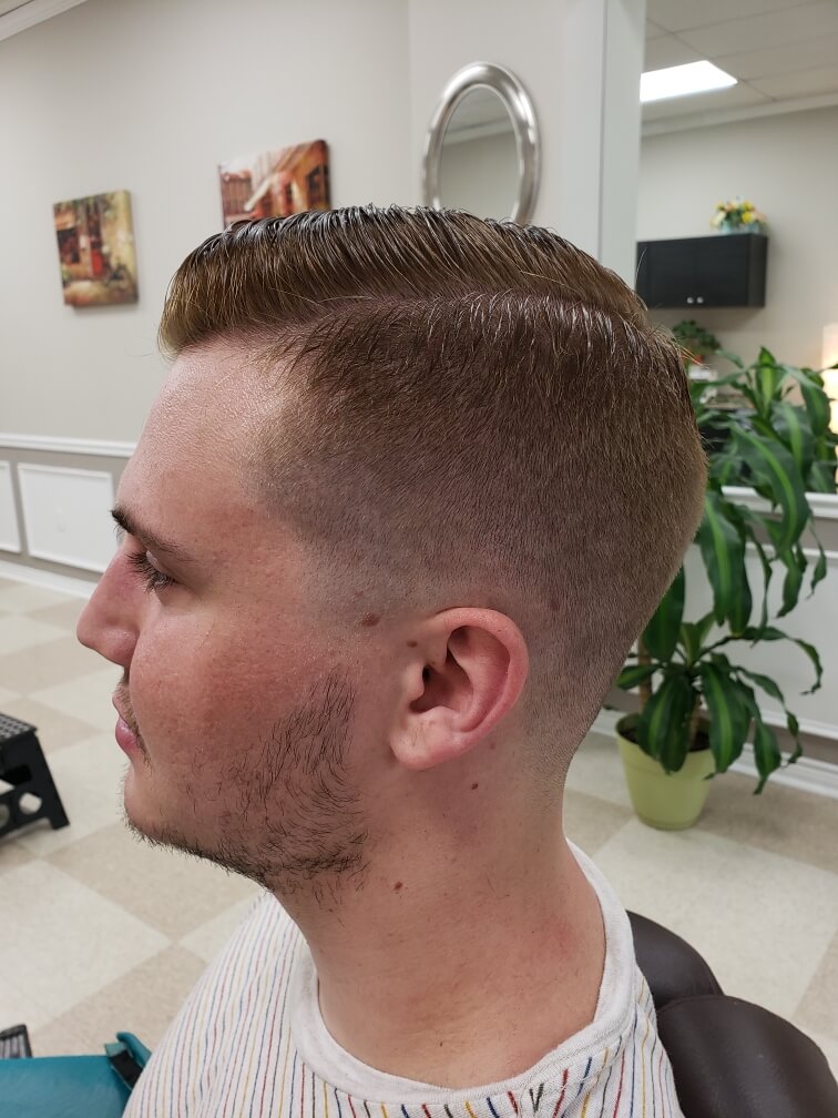 A side part with a taper fade through the sides.